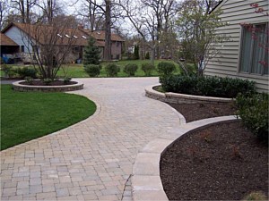 Paver walkway leading to a driveway